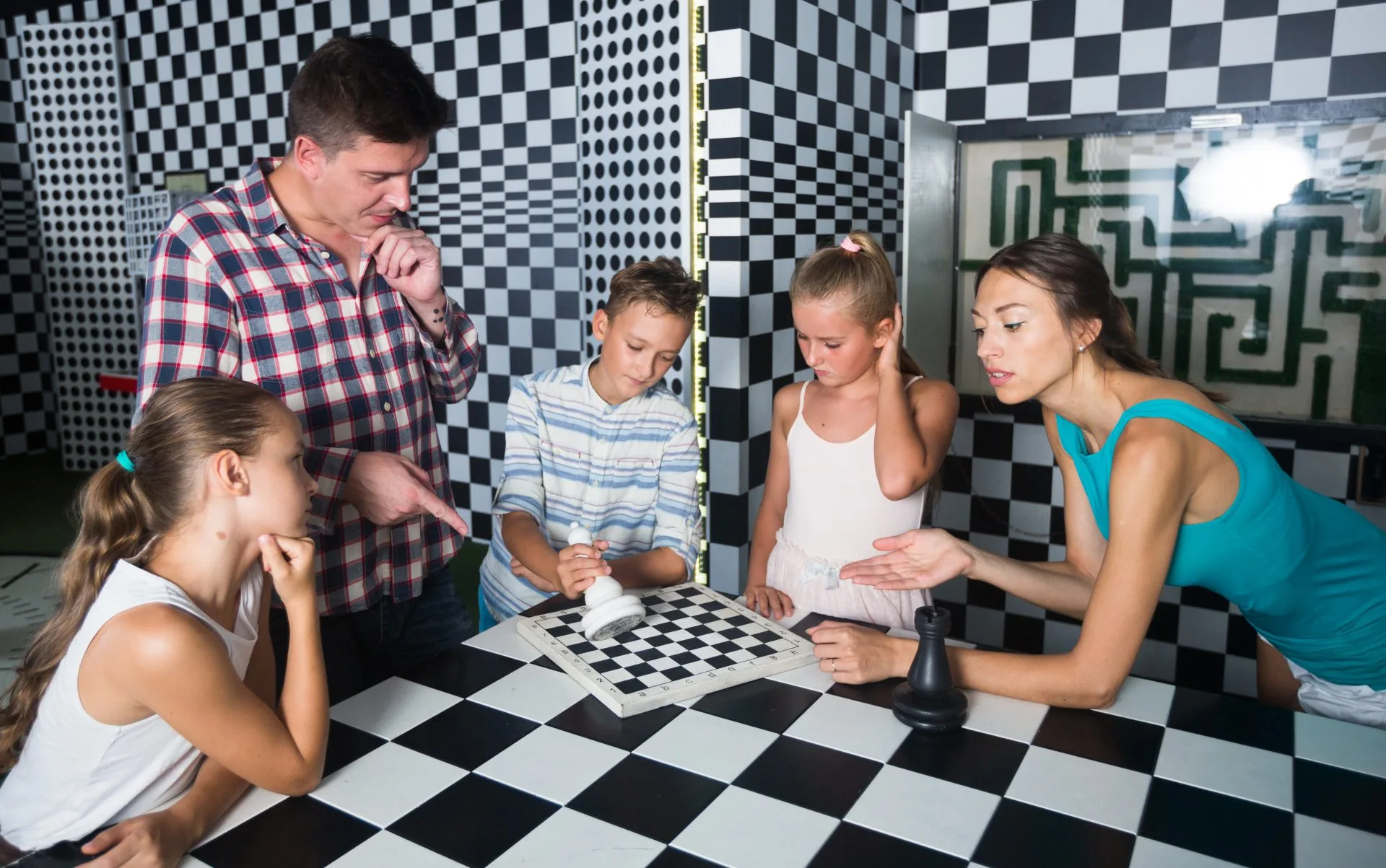 A small family leaning over printed clues, discussing solutions to an escape room puzzle